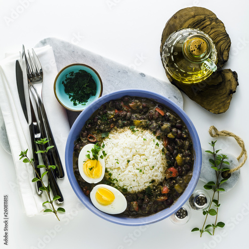rice with black beans and boiled egg on the table with spices and olive oil. healthy caribbean food © irinagrigorii