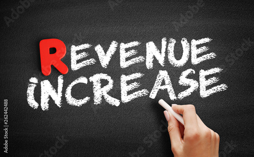 Revenue increase text on blackboard, business concept background © dizain