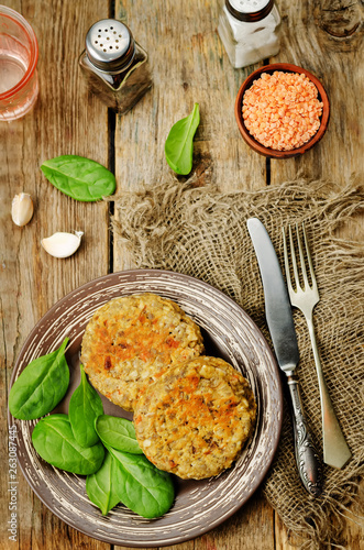 red lentil seeds cashew carrot burgers with fresh spinach leaves © nata_vkusidey