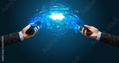 Two mobile phones syncing through the cloud © ra2 studio
