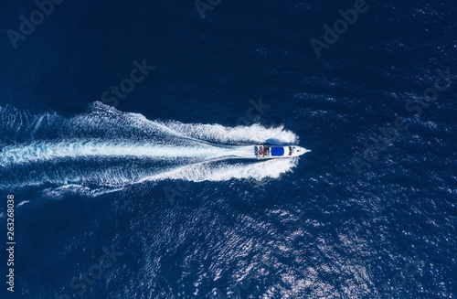 Yachts at the sea in Bali, Indonesia. Aerial view of luxury floating boat on transparent turquoise water at sunny day. Summer seascape from air. Top view from drone. Travel - image © Biletskiy Evgeniy