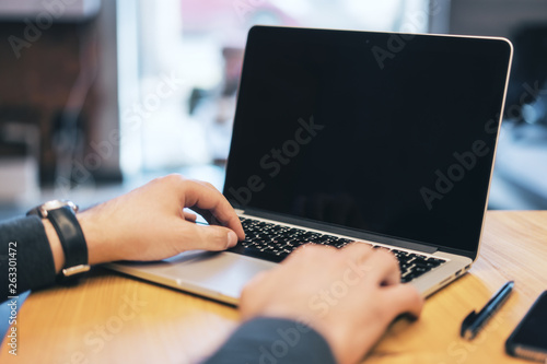 Man using empty laptop screen on desk © peshkov