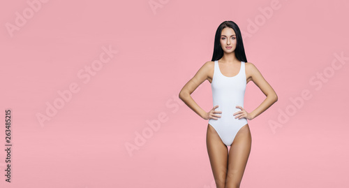 Fit and sporty girl in underwear. Beautiful and healthy woman posing in white swimsuit. Slim body. Sport, fitness, diet, weight loss and healthcare concept. © Maksim Šmeljov