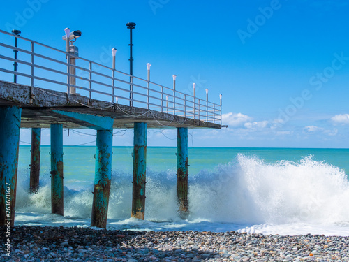Beautiful view of the pier and big waves © Anna_Berezkina