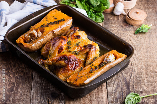 Roasted chicken with seasonal autumn butternut squash, garlic and herbs © istetiana