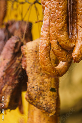 Smoked sausages meat hanging in smokehouse © Voyagerix