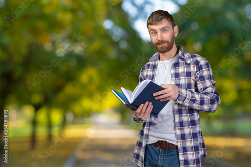 Young Man Holding Stack Of Books © fotofabrika