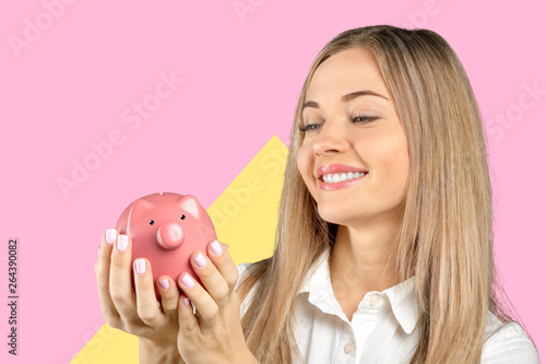Young woman with a piggy bank © fotofabrika
