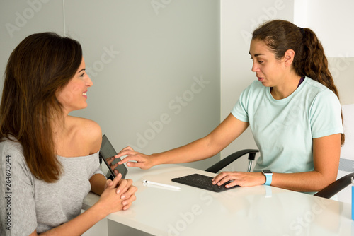 Female physiotherapist explaining diagnosis to her woman patient. © javiindy